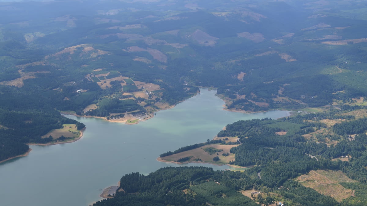 Aerial view of Henry Hagg Lake surrounded by forested hills