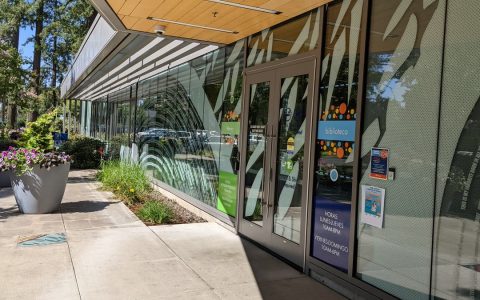 Glass entrance doors and a covered walkway at Shute Park Library